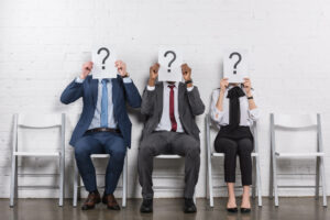 obscured view of multicultural business people holding cards wit